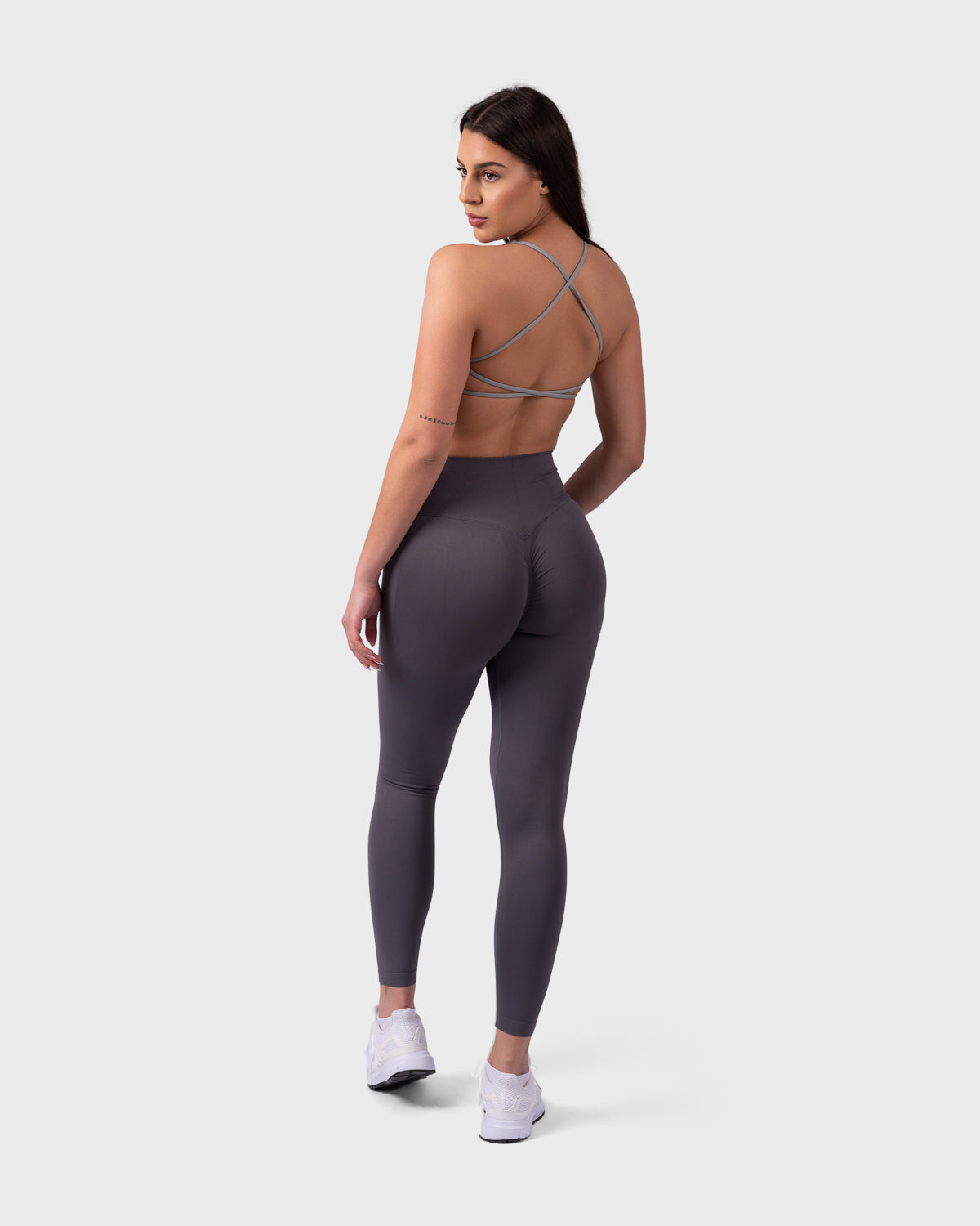 Full-body look featuring Evolve V-Sculpt Leggings and Evolve Backless Sports Bra in grey.