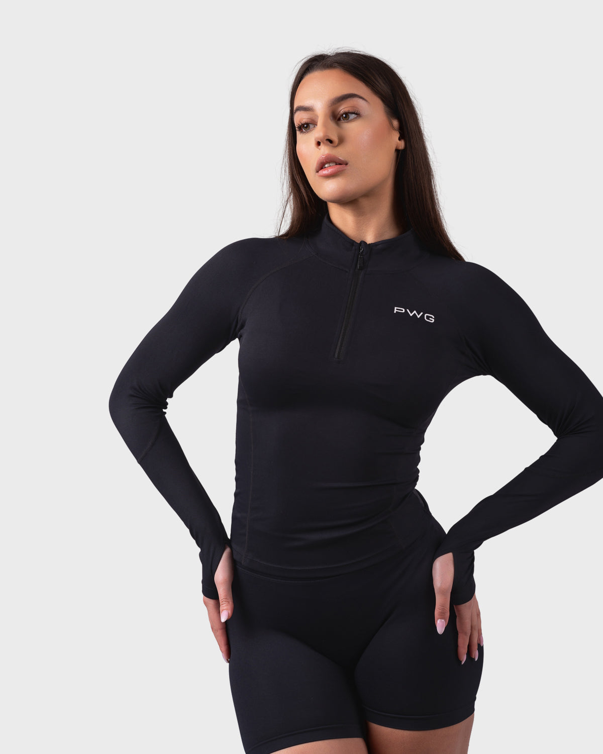 PWG Active Evolve 1/4 Zip Pullover in Black, breathable fabric, high neck, front PWG logo, and thumbhole sleeves for performance - Front View