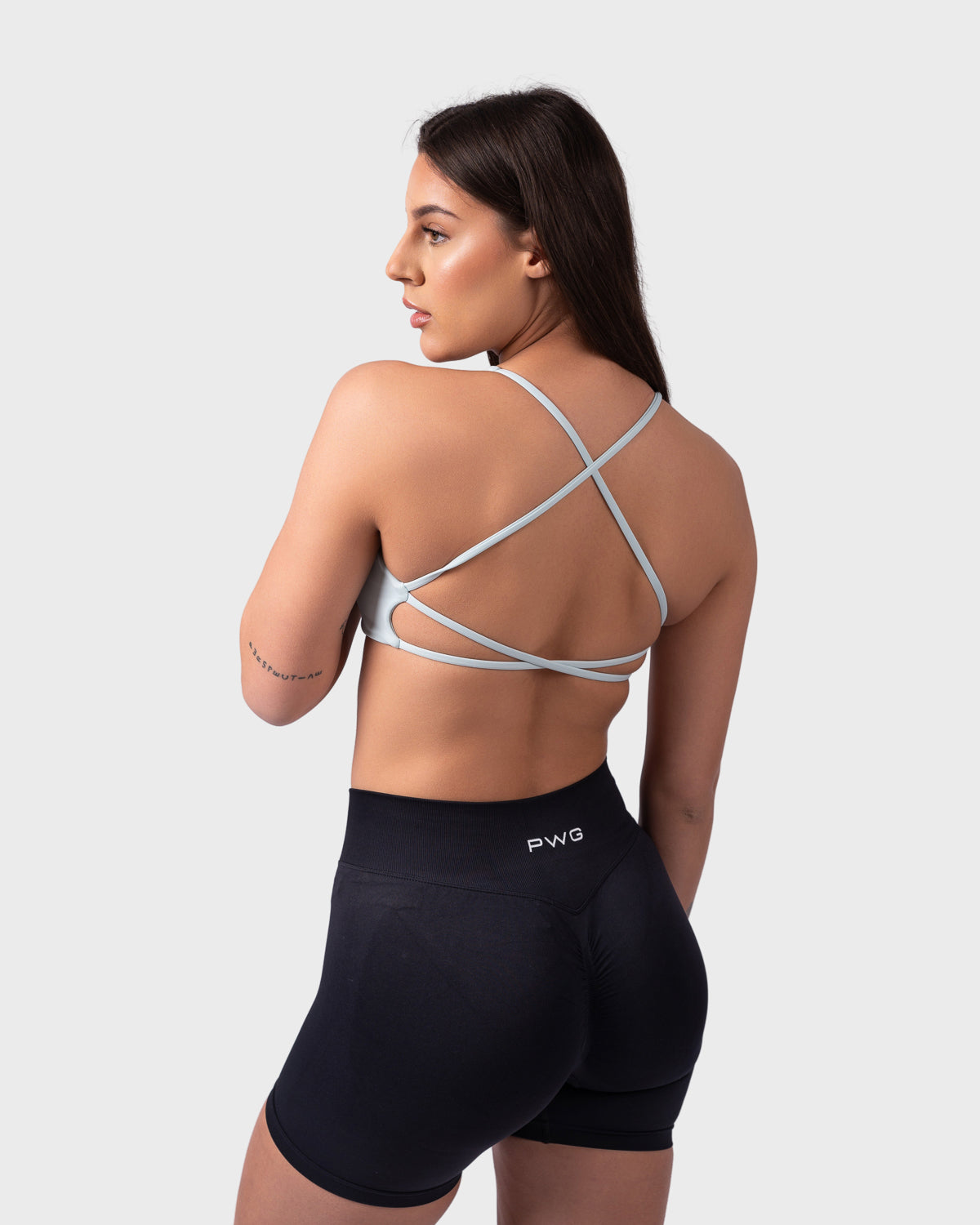 Rear view of Evolve Backless Bra in celeste, open-back with crisscross straps.