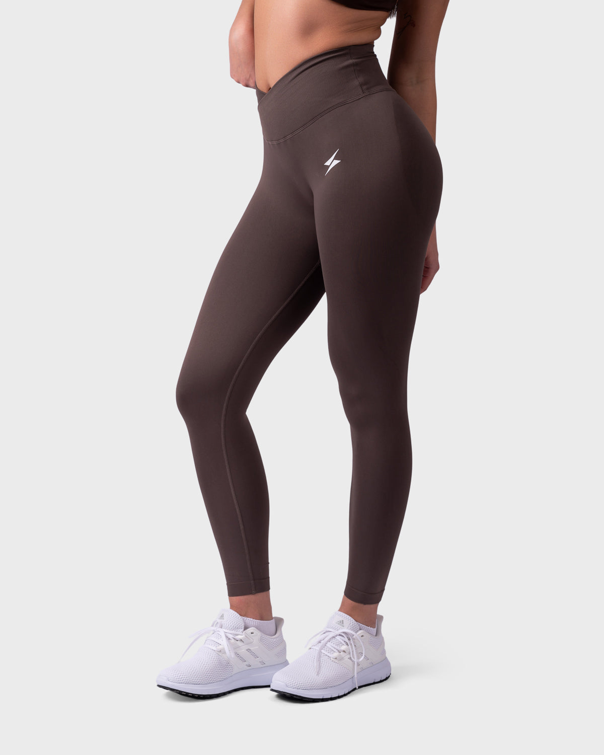 Side view of mocha Evolve Leggings, showing V-waistband and compressive fit.