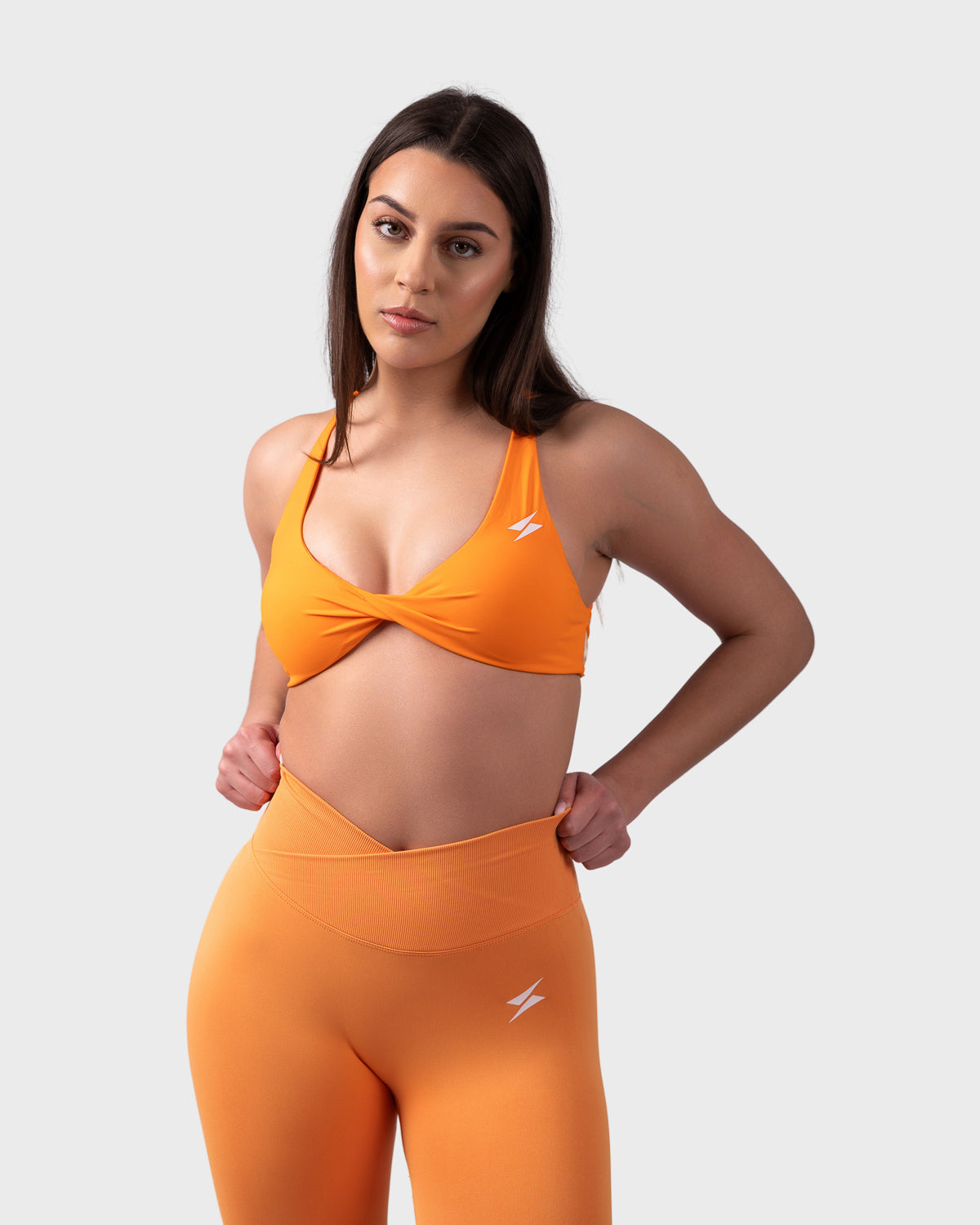 Front pose in Evolve Backless Sports Bra, styled with matching V-waist leggings.