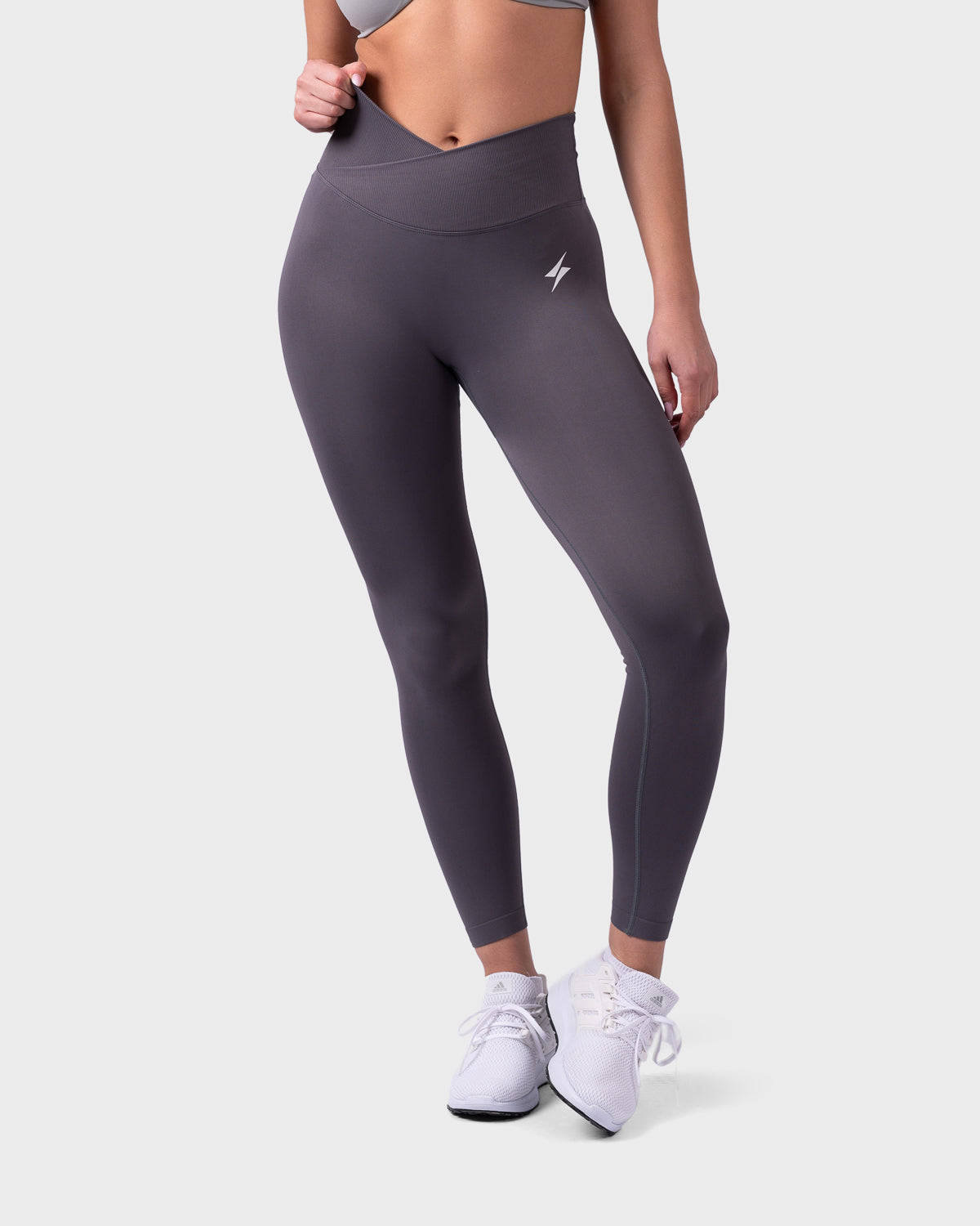 Front angle of onyx Evolve Leggings, showing V-waistband and smooth contour.