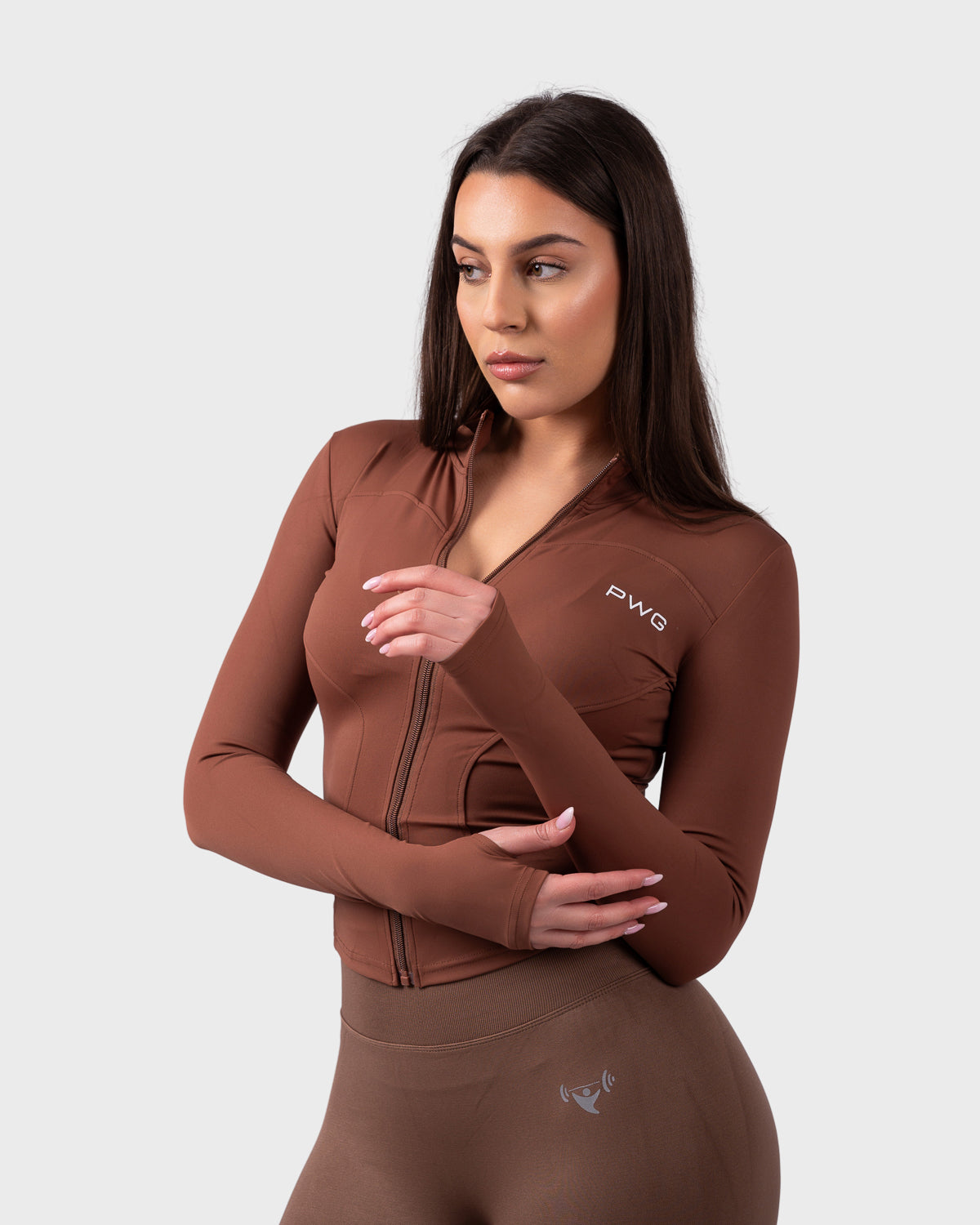 PWG Evolve Sculpt Fit Jacket in Chocolate, full zip, high neck, front PWG logo, thumbhole sleeves, breathable fabric