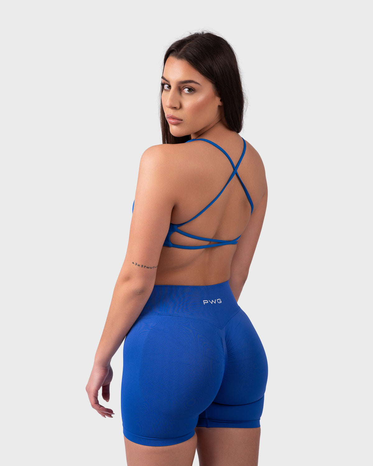 PWG Active Evolve Backless Sports Bra in Electric Blue, breathable, high-performance, with front logo design - Back View