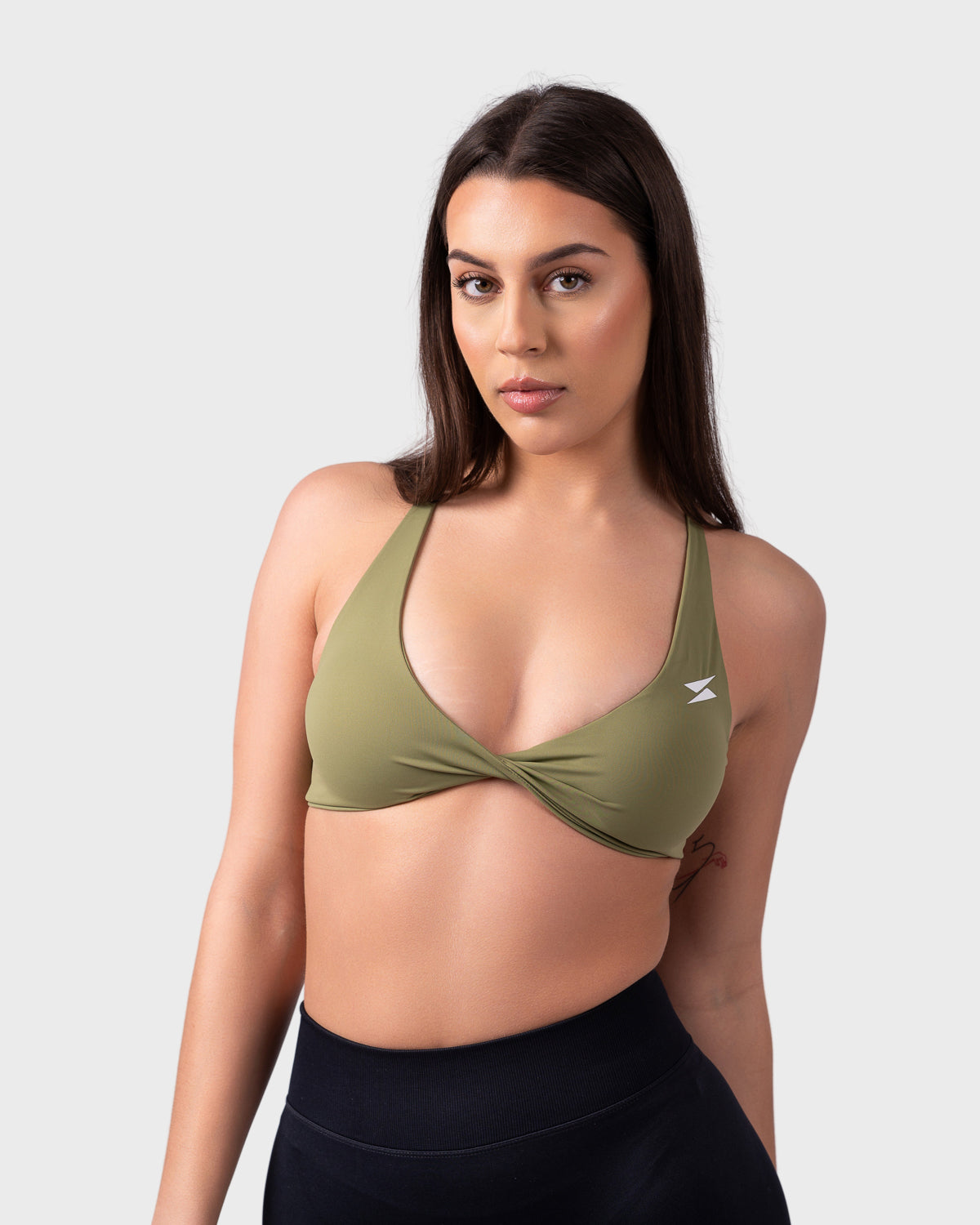 PWG Active Evolve Backless Sports Bra in Olive Green, breathable, high-performance, with front logo design - Front View