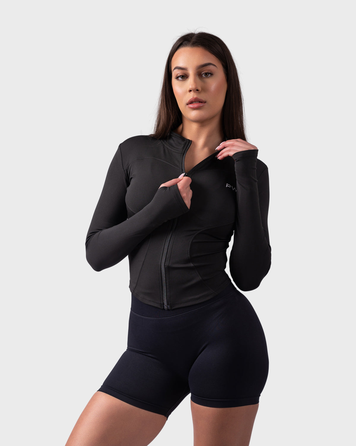 Evolve Sculpt Fit Jacket from PWG in black, front view with zip-up closure and slim fit.