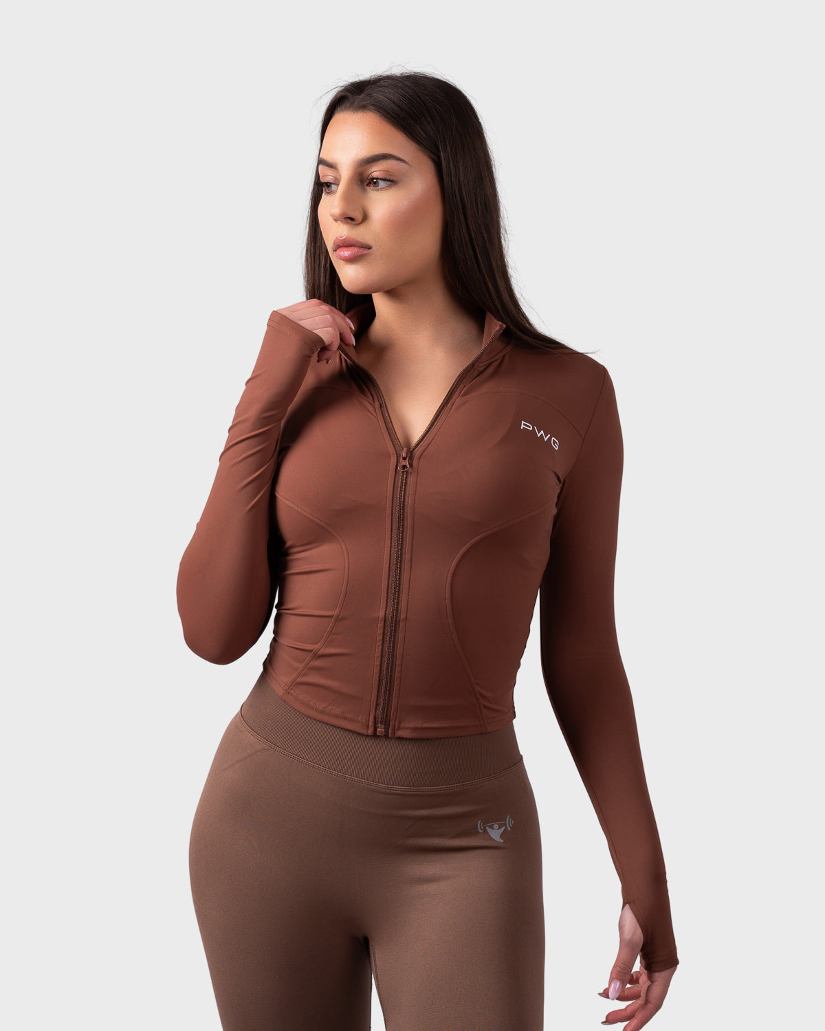 Evolve Sculpt Fit Jacket in chocolate brown, front view with zip and thumbholes.