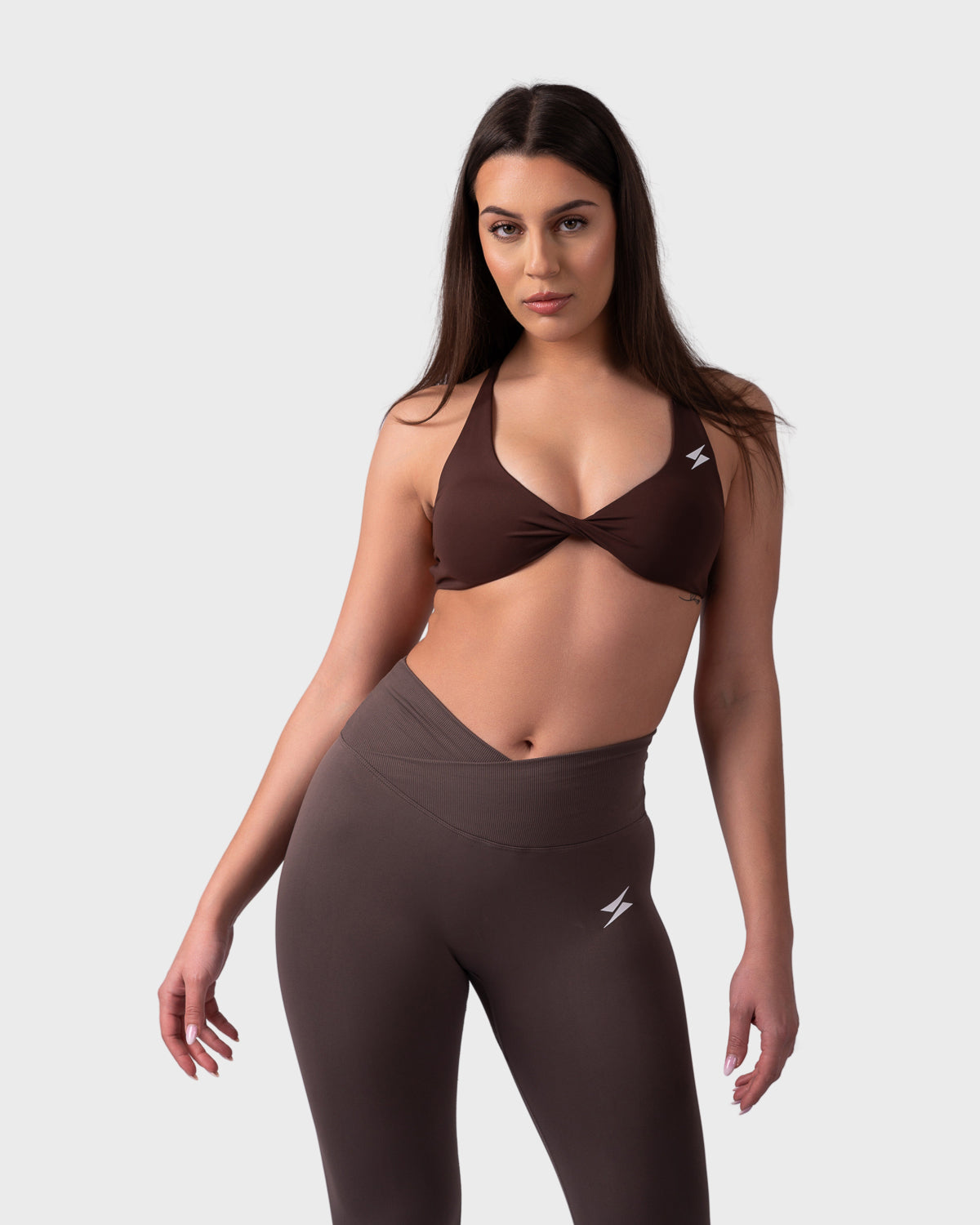 Full-body look in brown Evolve Backless Bra and leggings, relaxed confident stance.