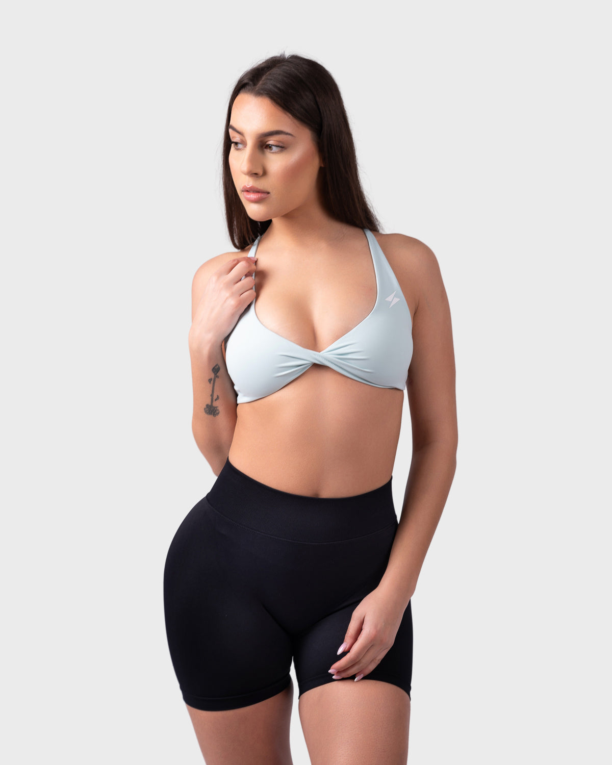 Angled front pose highlighting soft fit and V-cut neckline in celeste blue.