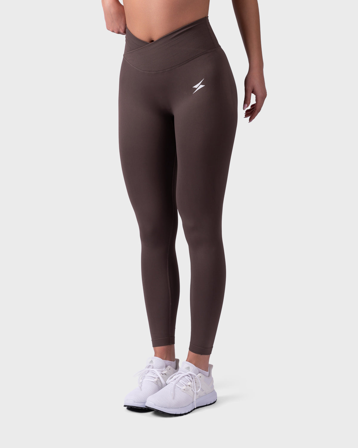 Angled front pose in mocha Evolve Leggings, pwg logo and sculpting detail.