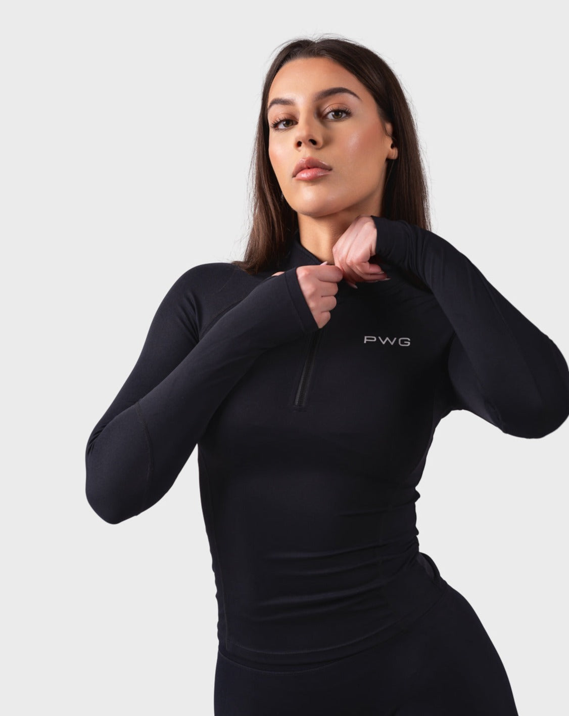 PWG Active Evolve 1/4 Zip Pullover in Black, breathable fabric, high neck, front PWG logo, and thumbhole sleeves for performance
