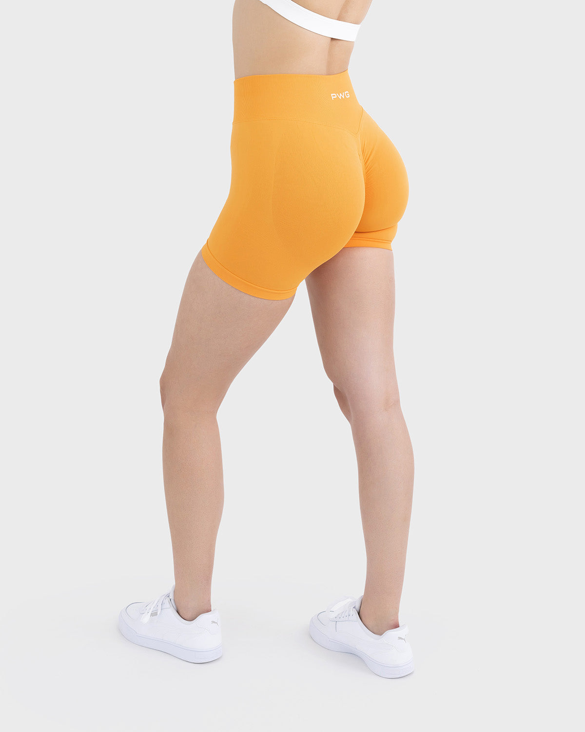 PWG Active Form Sculpting Shorts in Amber Blaze, high ribbed waistband, sculpting design, scrunch back, 4” inseam - Side View