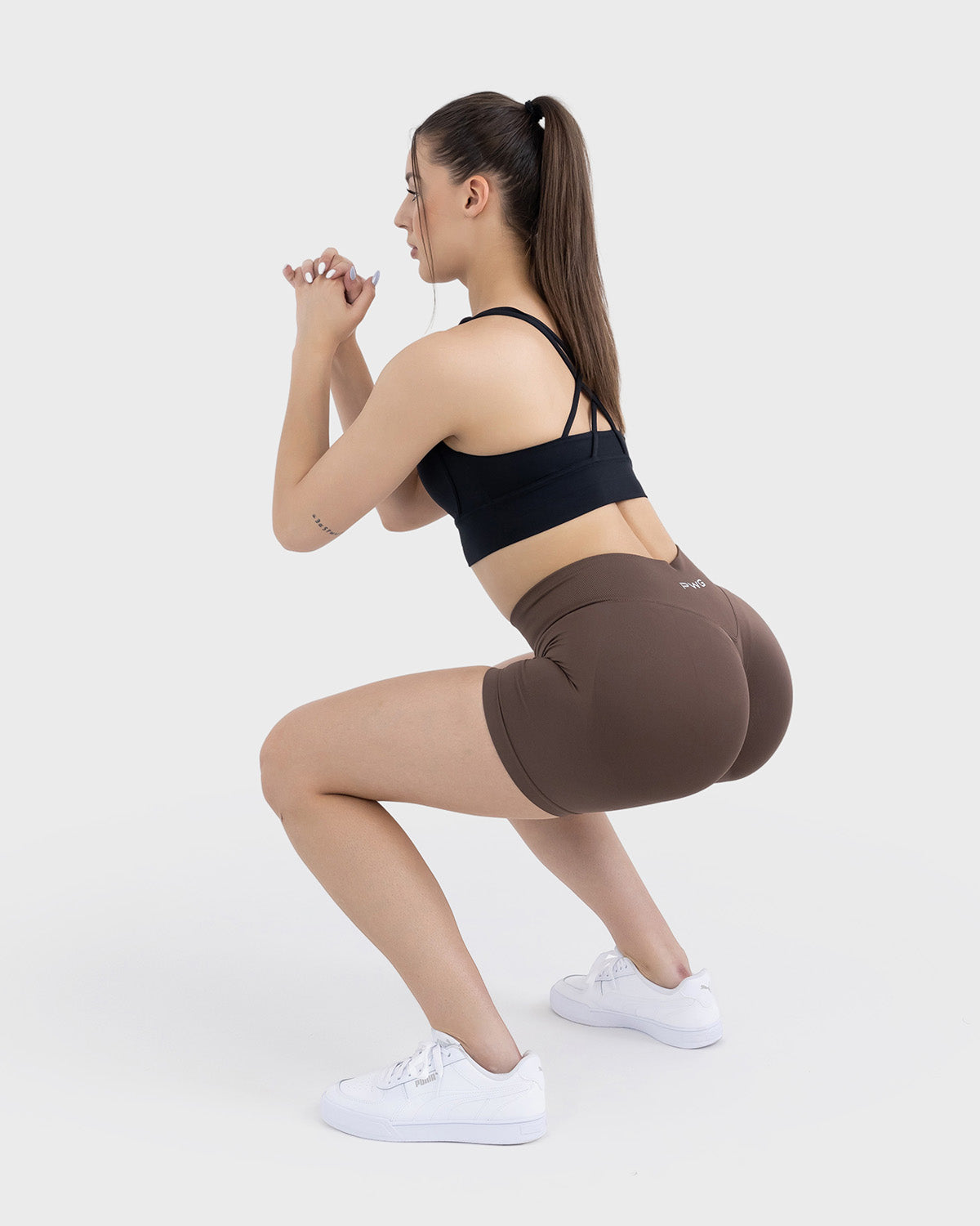 PWG Active Form Sculpting Shorts in Espresso Walnut, high ribbed waistband, sculpting design, scrunch back, 4” inseam - Squat Back View