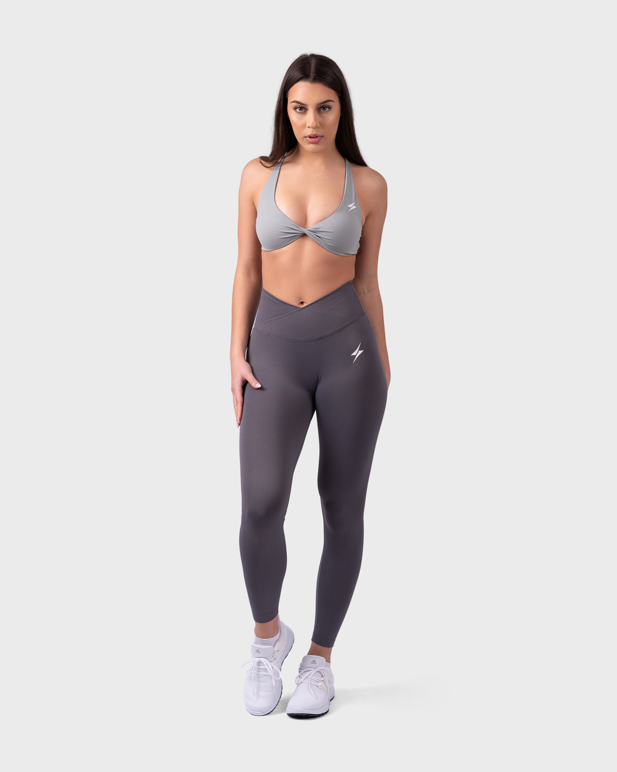 Full-body look in Evolve Backless Sports Bra and leggings, model standing straight.