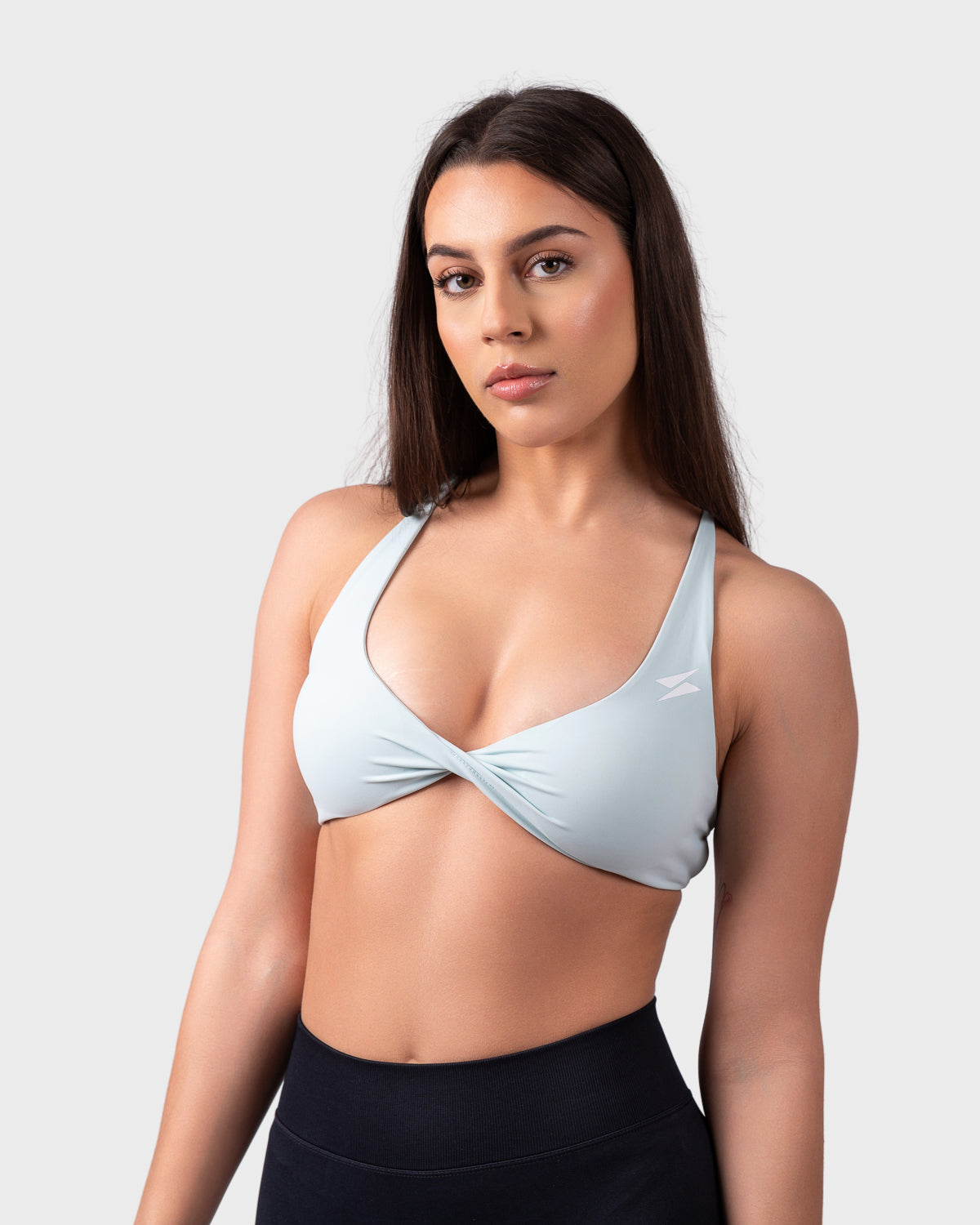 PWG Active Evolve Backless Sports Bra in celeste blue, front view with twist-front design.