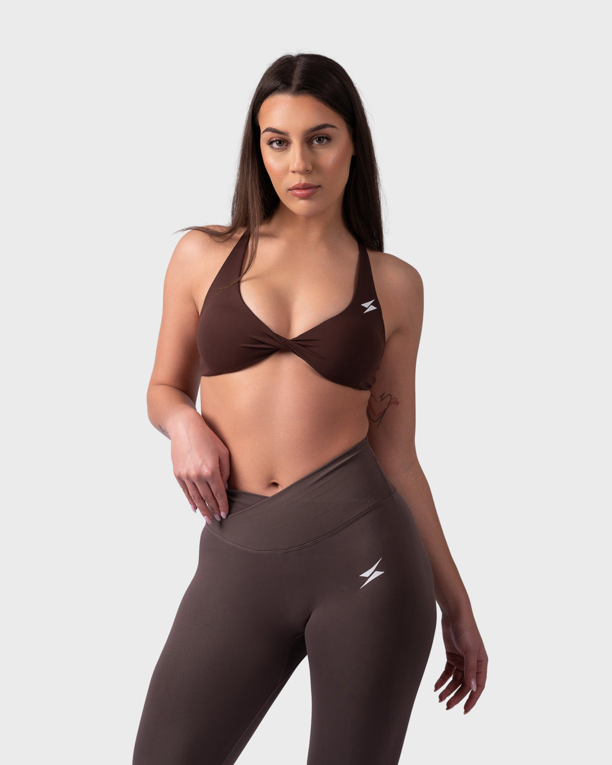 Front view of brown backless bra styled with matching leggings, soft sculpting fit.