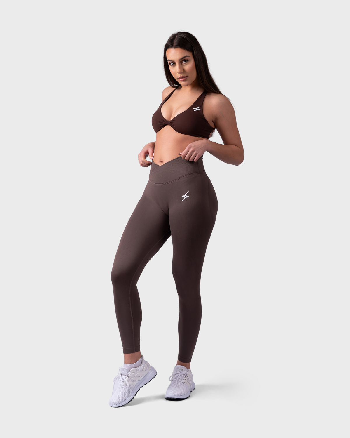 Model in Evolve V-Sculpt Leggings and matching brown backless bra, front stance.
