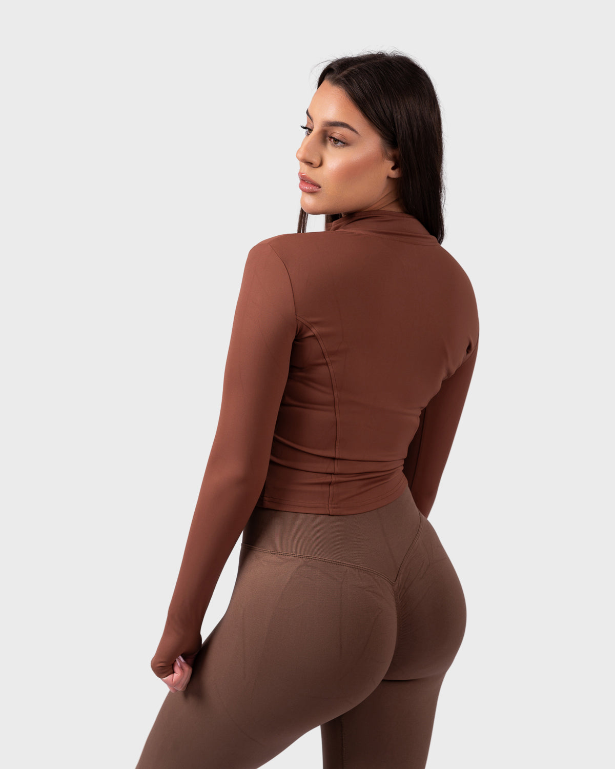 Back view of Evolve Sculpt Fit Jacket in chocolate, showcasing curved seams and snug fit.