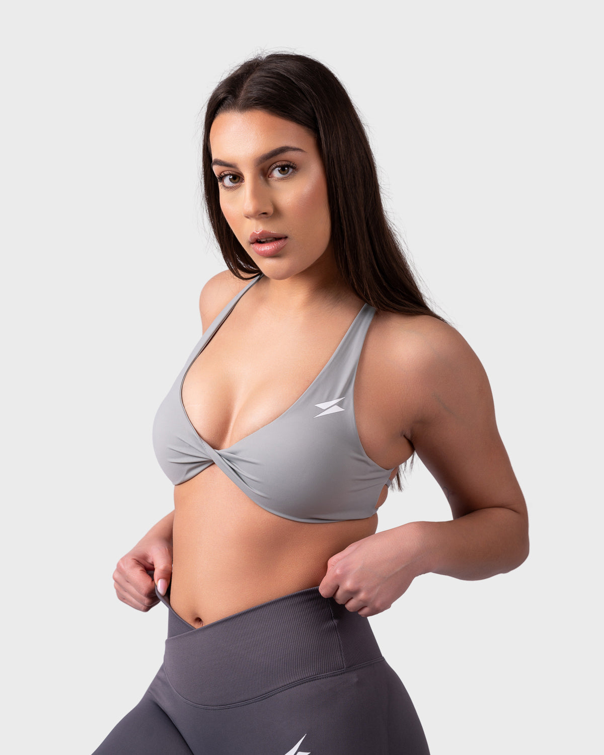 Evolve Backless Sports Bra from PWG Active in grey, twist-front design and scoop neckline.