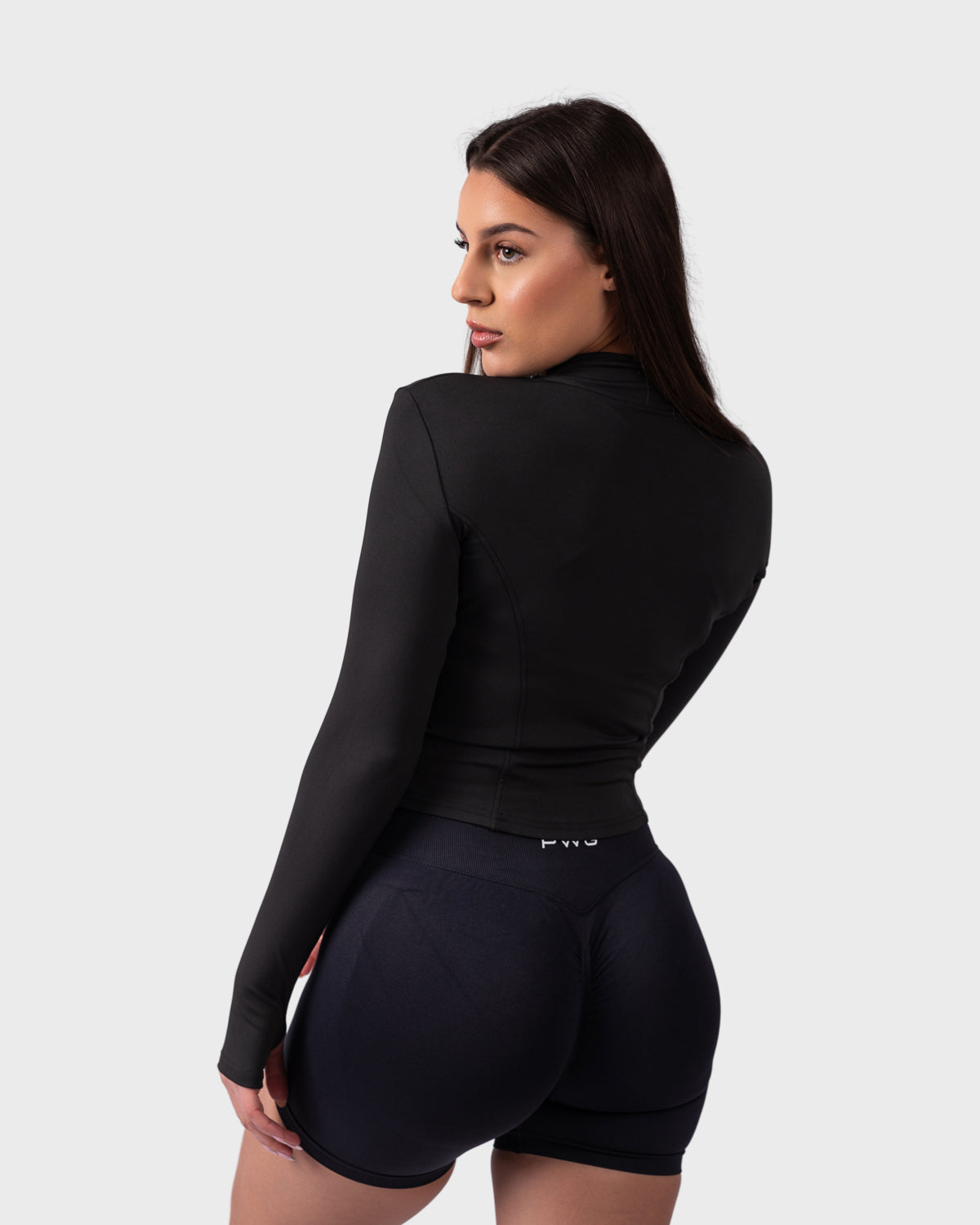 Back view of black sculpt fit jacket, highlighting contour seams and logo detail.