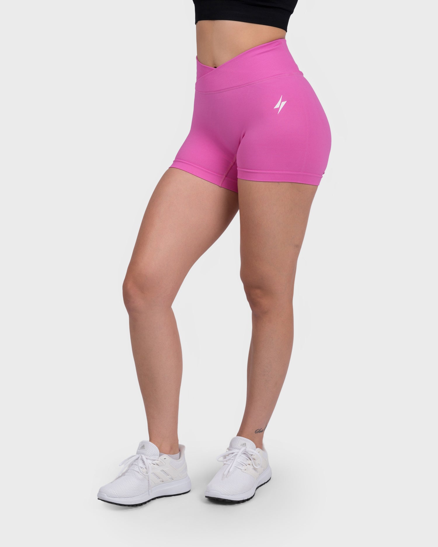 Evolve V-Sculpt Shorts from PWG Active in hot pink, front view with V-cut waistband.