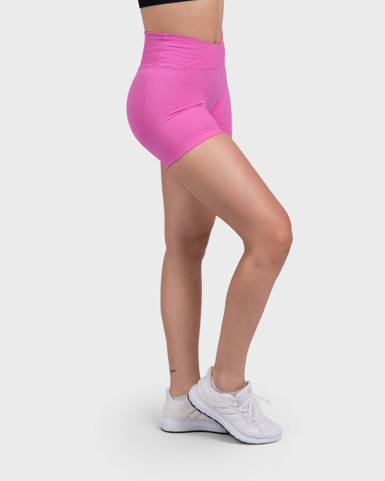 Side angle of Evolve V-Sculpt Shorts in hot pink, showing sculpted thigh fit.