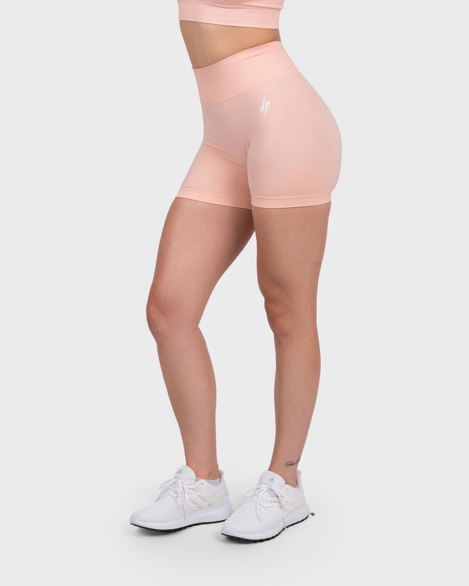 Light peach FlexActive Shorts, angled side view showing high waistband and fit.