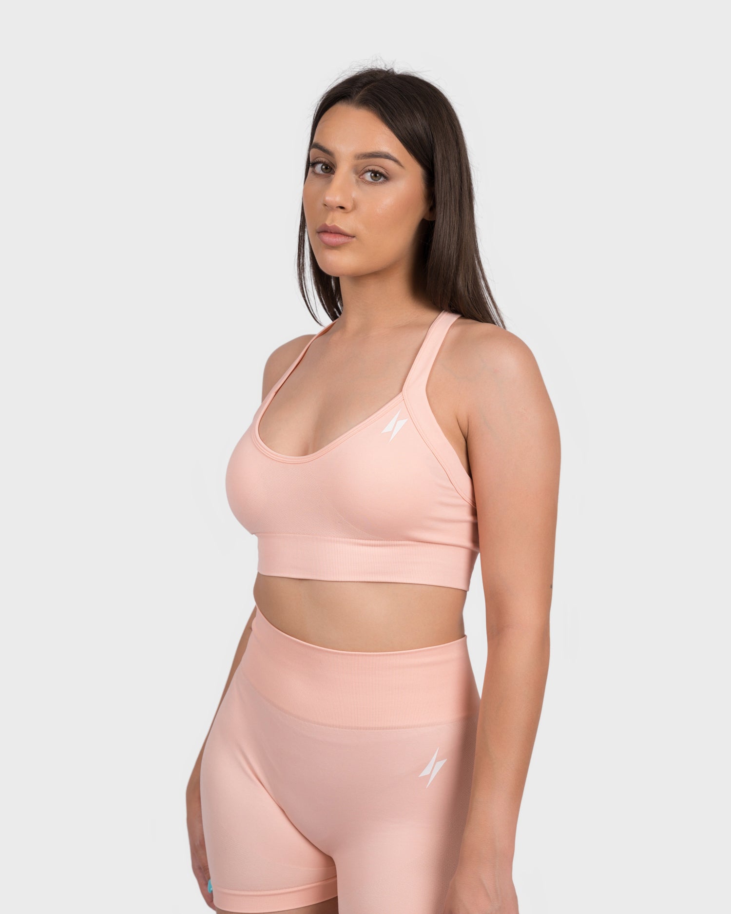 FlexActive Sports Bra from PWG Active in light peach, front view with scoop neckline.