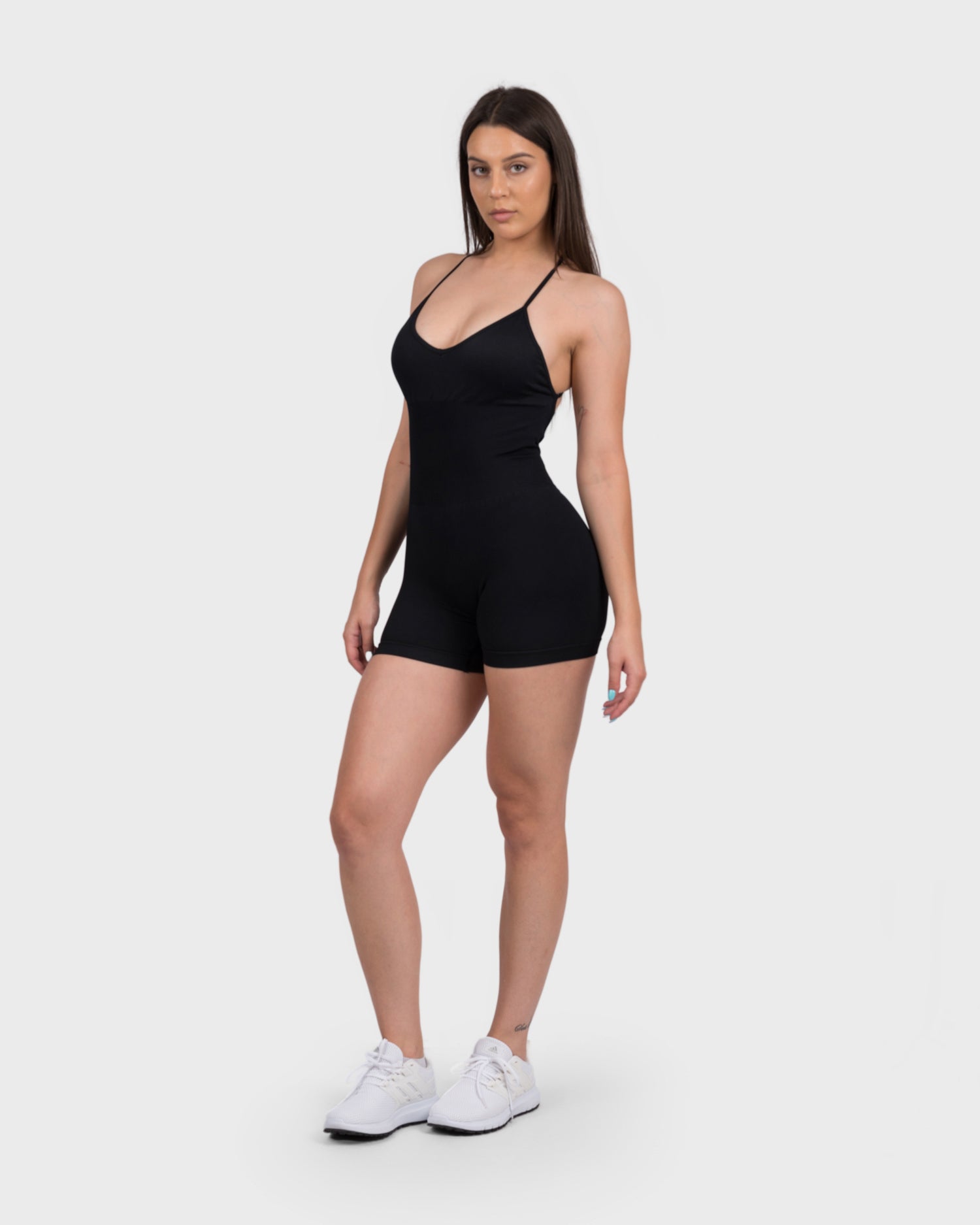FlexActive Sculpting Backless Jumpsuit from PWG Active in black, front view with scoop neckline.