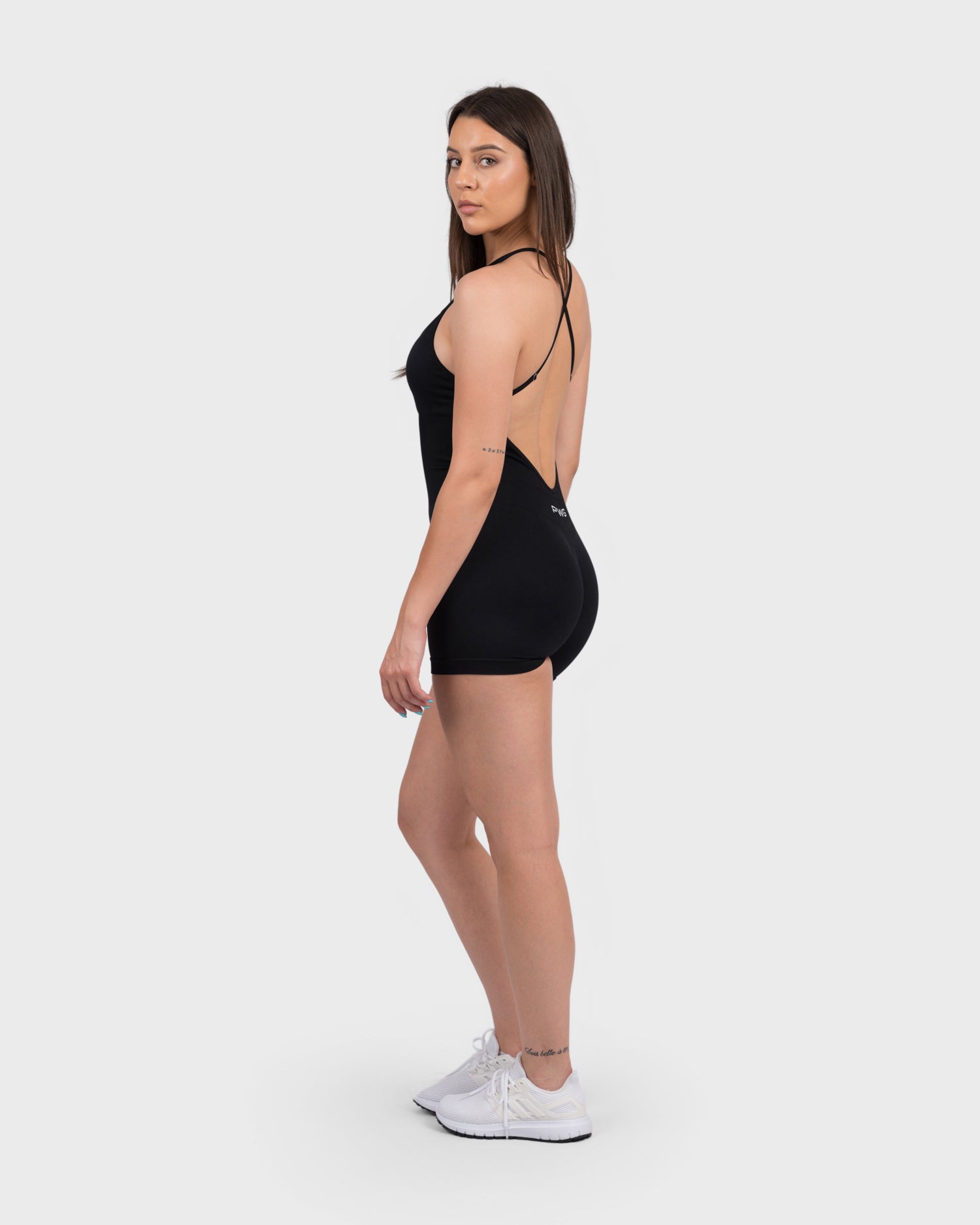 Side angle of FlexActive Sculpting Backless Jumpsuit showing contour and deep side cut.
