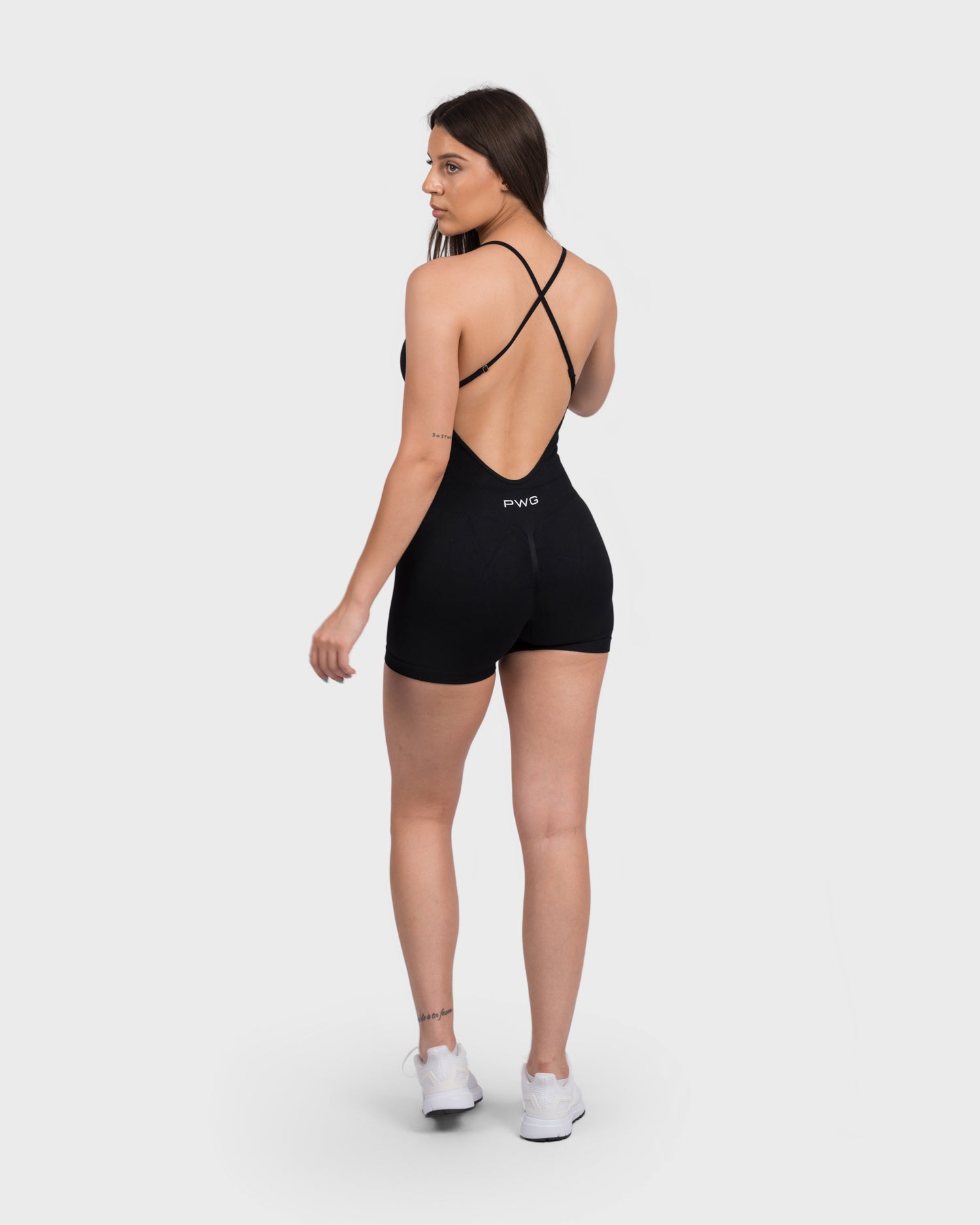 Back view of FlexActive Sculpting Jumpsuit in black, showing open back and cross straps.