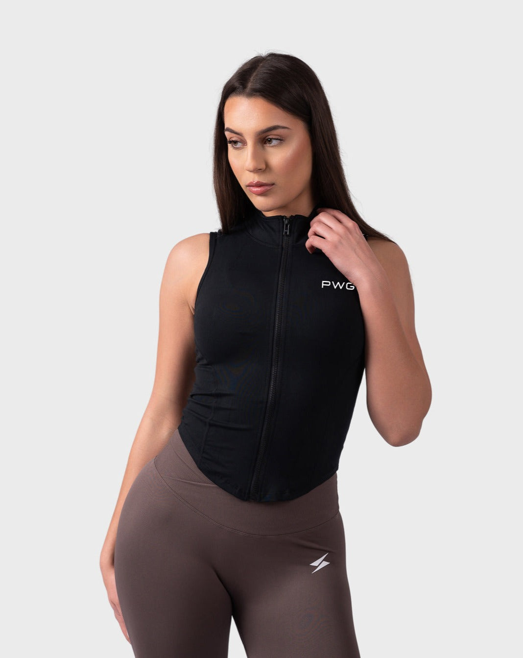 Evolve Sleeveless Jacket from PWG Active in black, front view with fitted design and high neck.