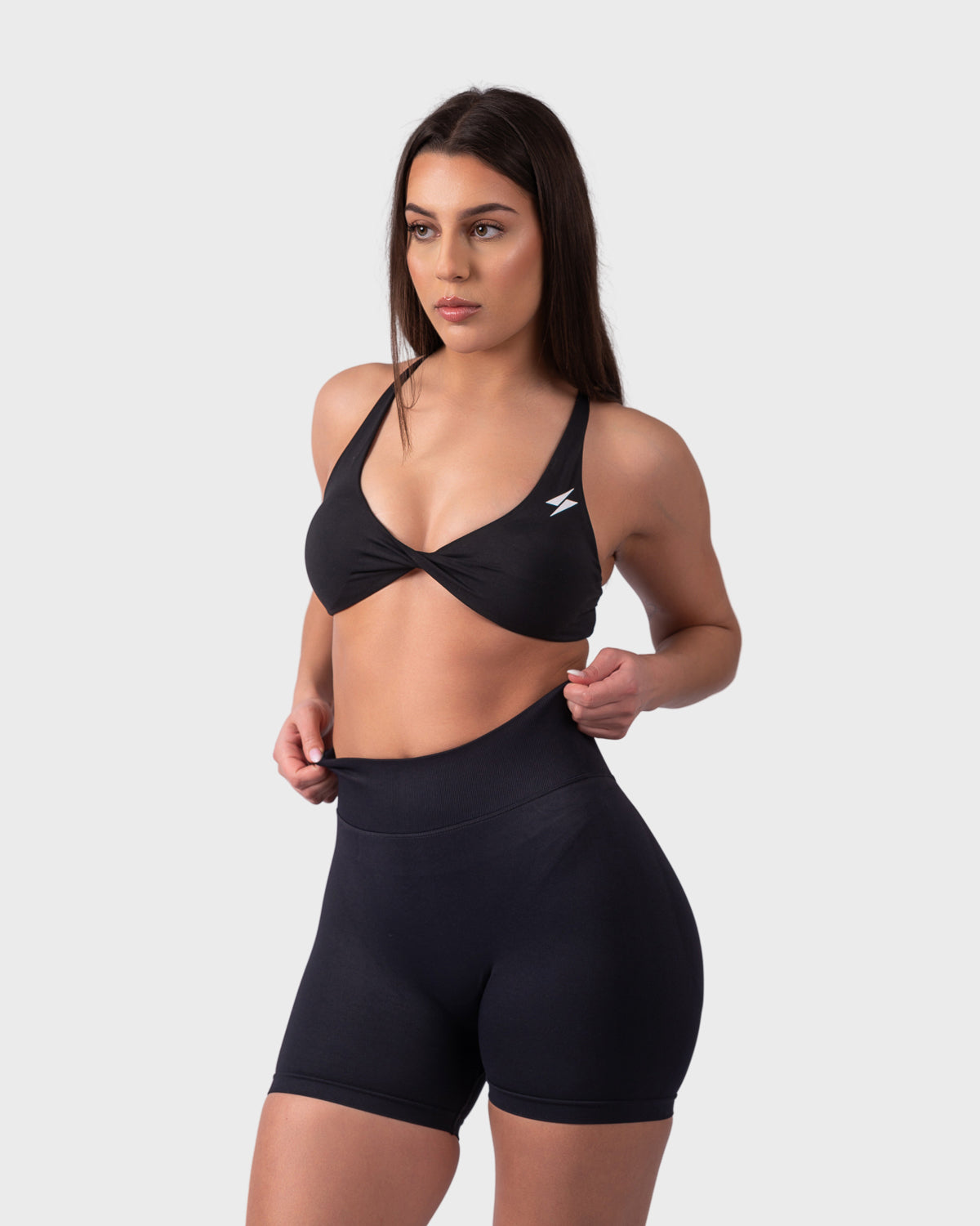 Side view highlighting secure fit and supportive underband in black bra.