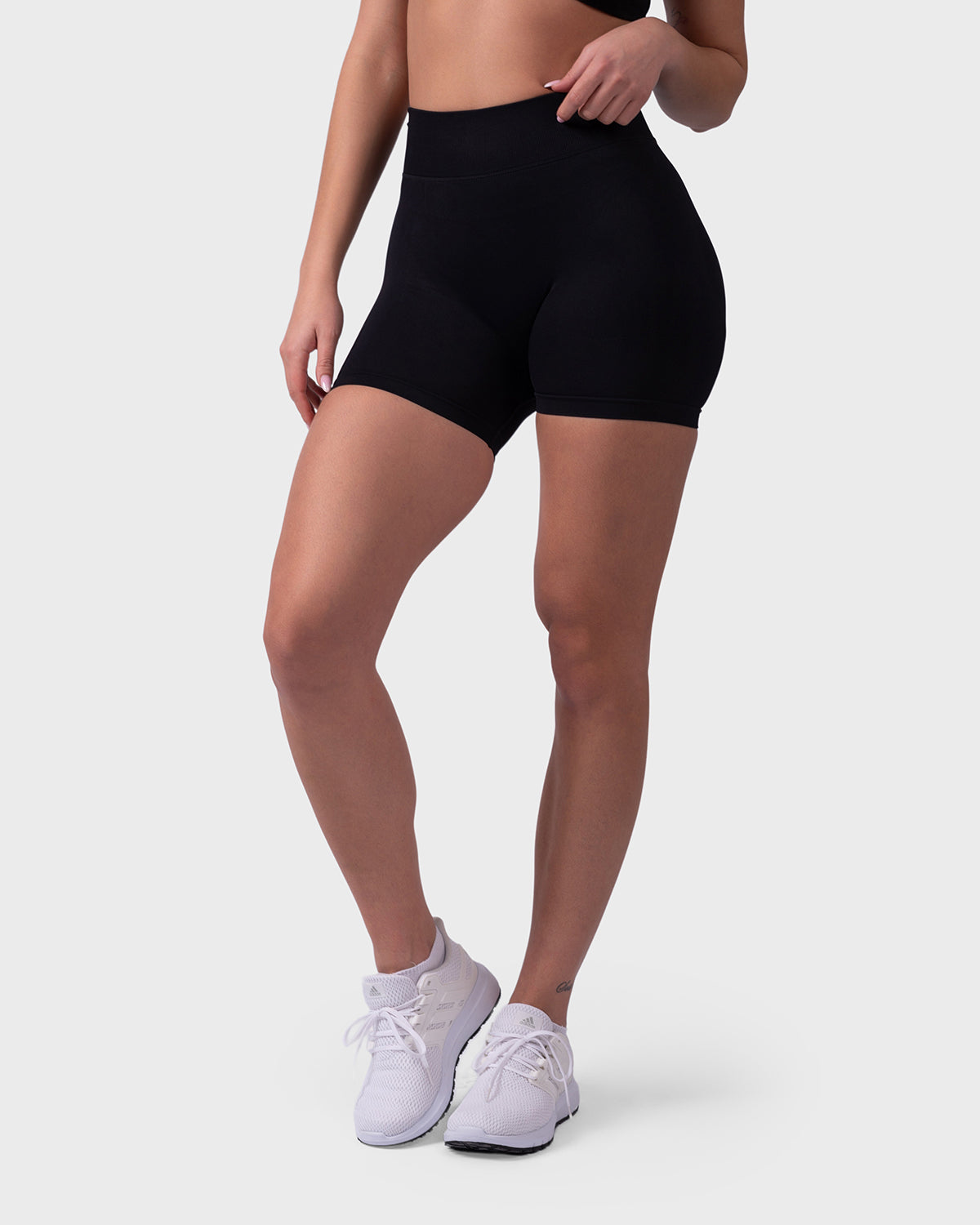 Front angle of Form Sculpting Shorts in black, highlighting glute fit and sleek silhouette.
