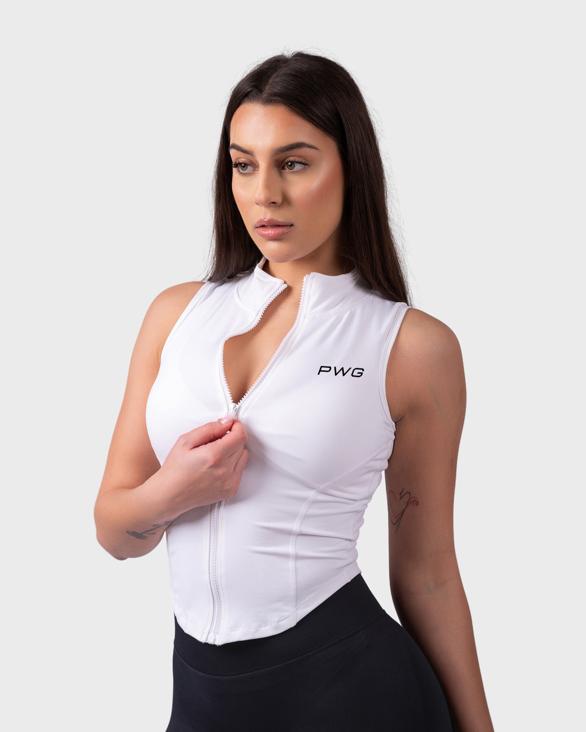 Evolve Sleeveless Jacket from PWG Active in white, front view with half-zip detail.