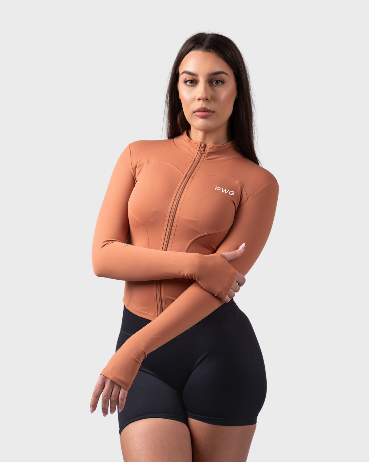 Relaxed stance in caramel toffee jacket, full-zip and long sleeves on display.