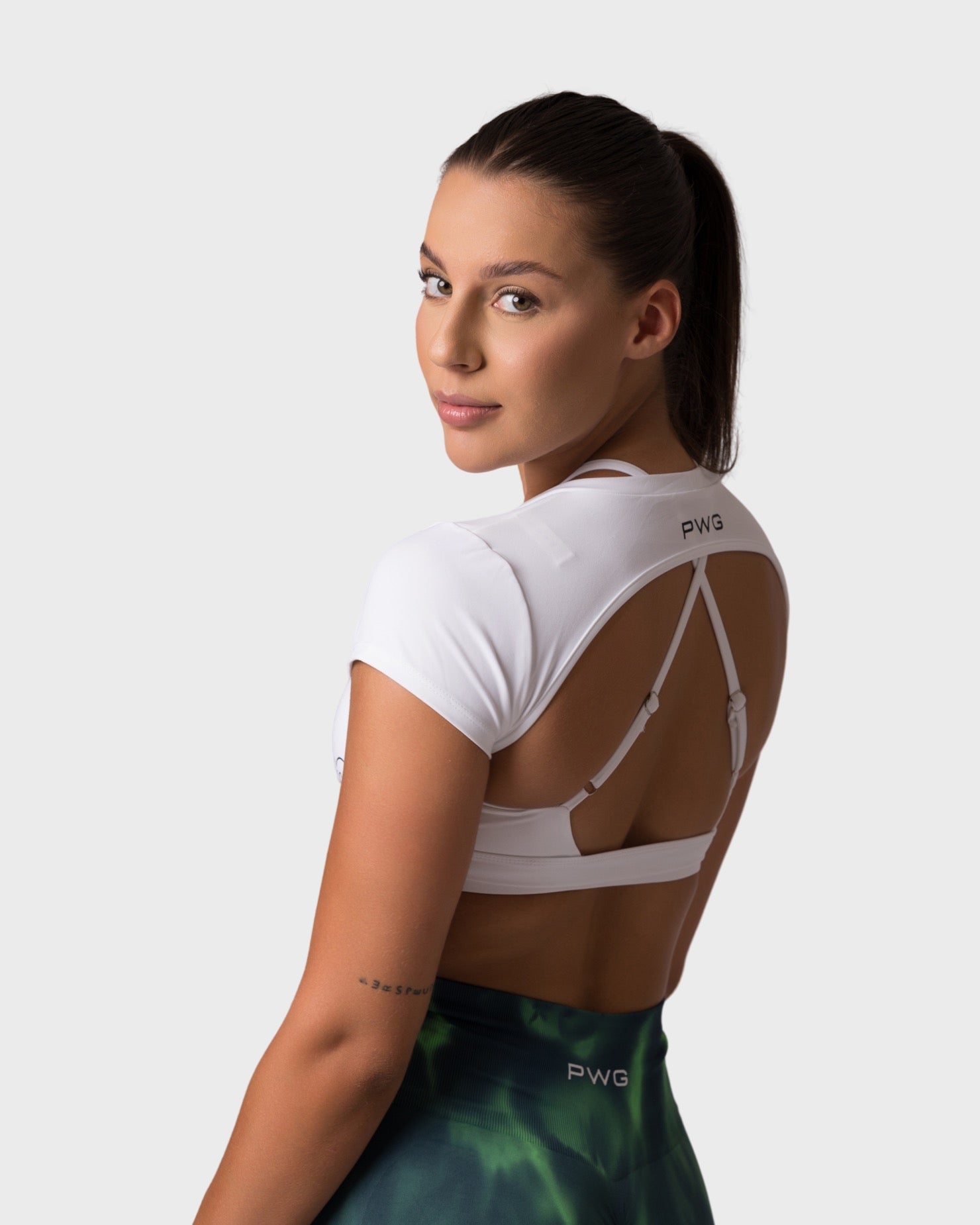 Back view of PWG x CC Short Sleeve Top in White, open back design for confidence and style