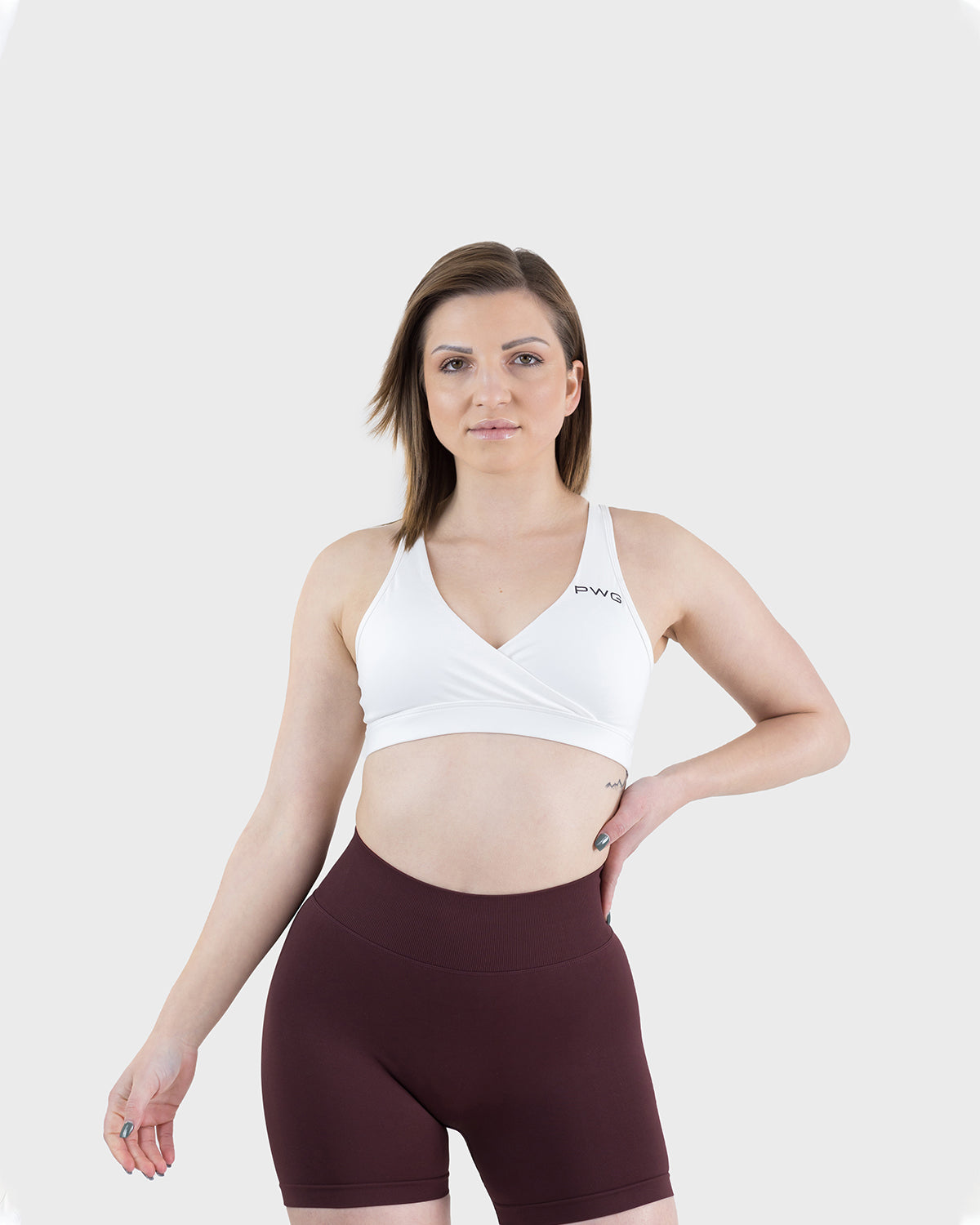 PWG Active Form Open Back Sports Bra in White, plunge V-neck, open back, medium support, removable padding, heat-sealed logo - Front View