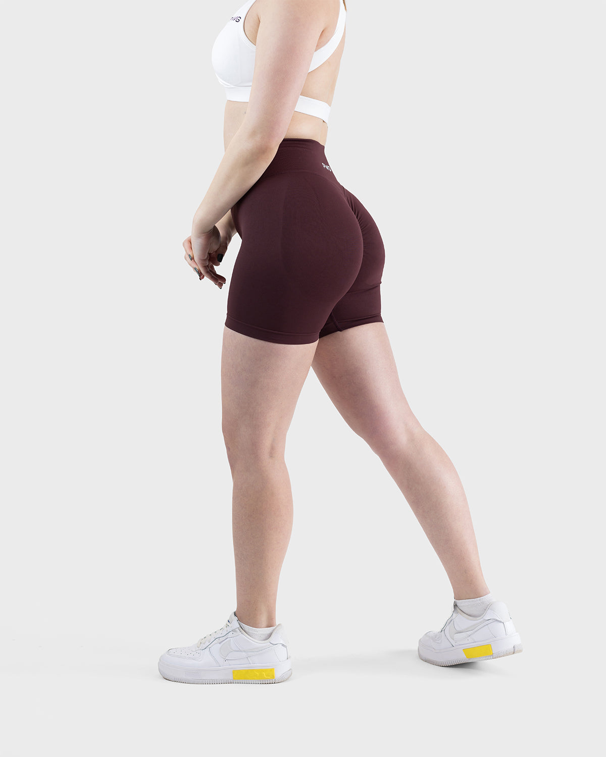PWG Active Form Sculpting Shorts in Dark Burgundy, high ribbed waistband, sculpting design, scrunch back, 4” inseam - Side View
