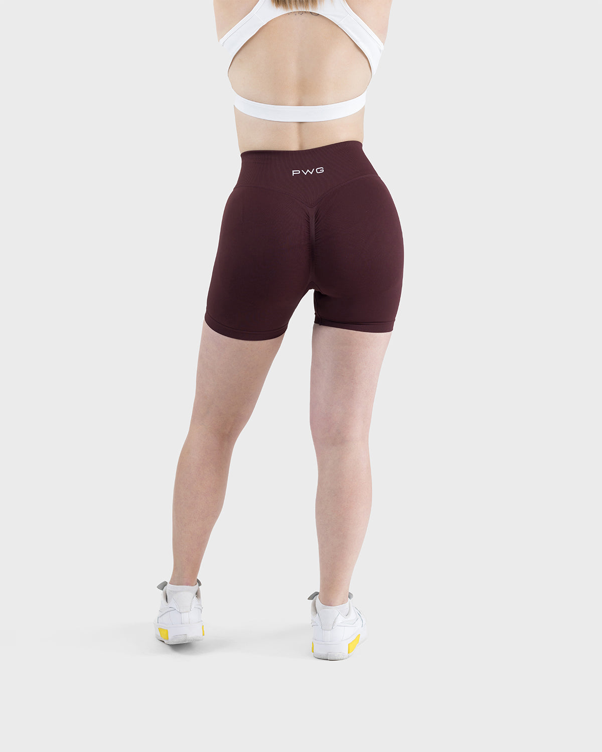 PWG Active Form Sculpting Shorts in Dark Burgundy, high ribbed waistband, sculpting design, scrunch back, 4” inseam - Back View