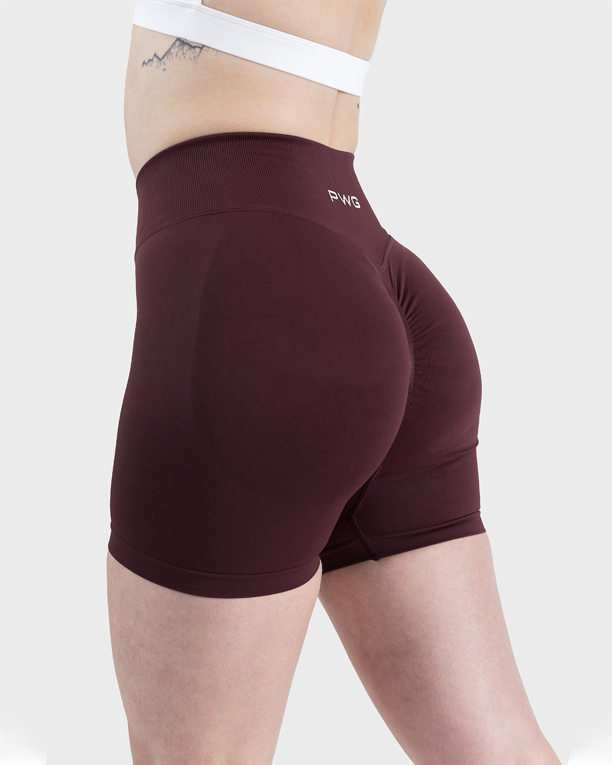 PWG Active Form Sculpting Shorts in Dark Burgundy, high ribbed waistband, sculpting design, scrunch back, 4” inseam - Side View
