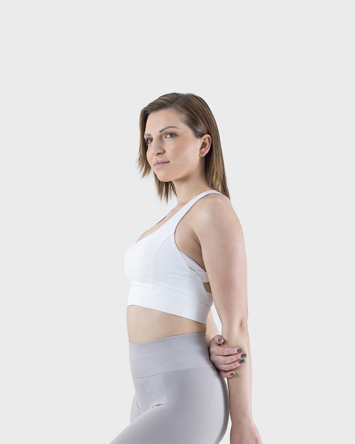 PWG Active Arise Sports Bra in White, body fit, medium support, crossed back straps, plunge neckline, removable padding - Side View