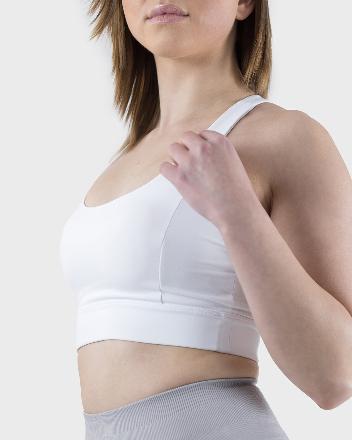 PWG Active Arise Sports Bra in White, body fit, medium support, crossed back straps, plunge neckline, removable padding