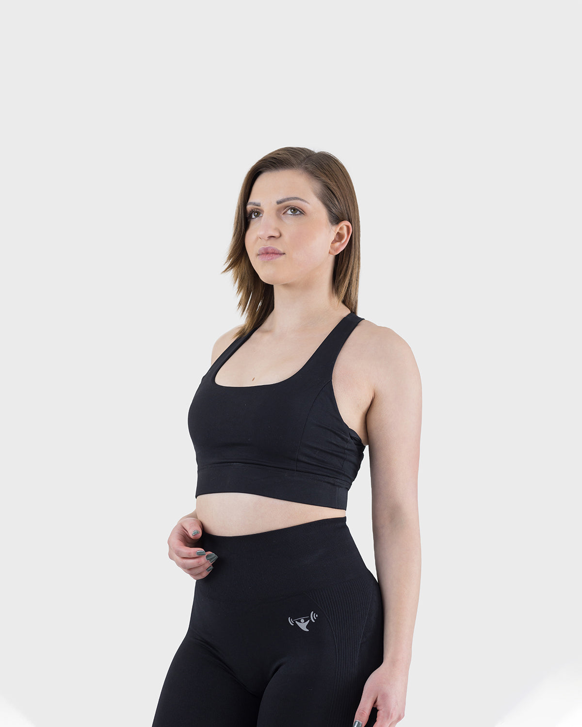 PWG Active Arise Sports Bra in Black, body fit, medium support, crossed back straps, plunge neckline, removable padding - Front view