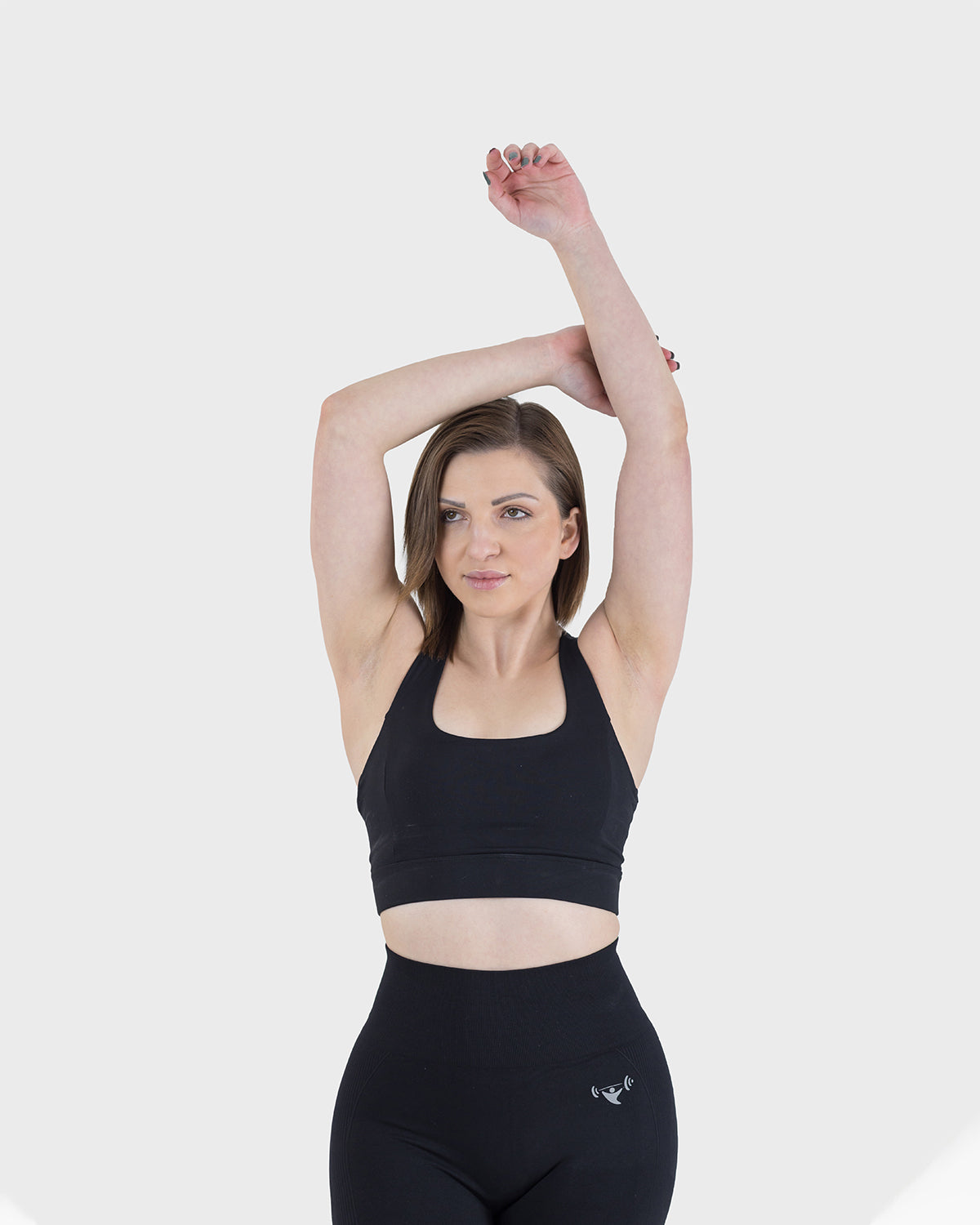 PWG Active Arise Sports Bra in Black, body fit, medium support, crossed back straps, plunge neckline, removable padding - Front View
